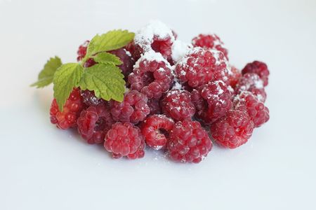 Fresh raspberries on the white background