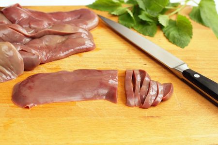 Cutting of pork kidneys preparing for stewing の写真素材