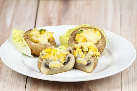 Grilled mushrooms. Mushroom filled  with eggs and cheese. Mushrooms on plate. Tasty mushroom.の写真素材