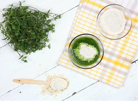 Homemade herb facial mask from  finely ground oat and herb. Common chickweed, Stellaria media for smooth and healthy face. The rest you can eat. Top view, copy space.の写真素材