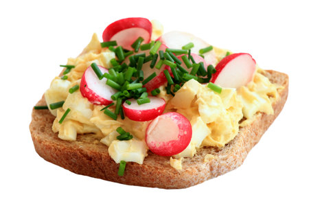Egg salad with radish and chives over whole grain toast. Homemade spread made from eggs and processed cheese on white.の写真素材