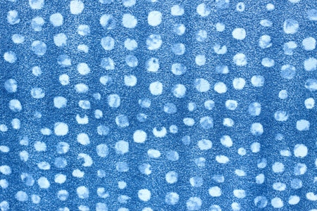 Blue flannel cloth with white dots. The background of knitted soft dotted flannel material.