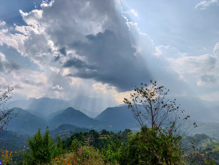 Sun rays coming out of cloudsの写真素材