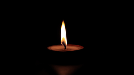 One butter lamp candle glowing in the dark, mainly used during Diwali or Deepawali festivalの写真素材