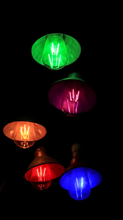 Colorful lights hanging in the darkの写真素材