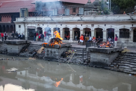 Kathmandu, Nepal - November 4 2018: People, Friends and family watching cremation of a dead body at Pashupatinath Temple Premisesのeditorial素材