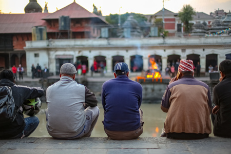 Kathmandu, Nepal - November 4 2018: People, Friends and family watching cremation of a dead body at Pashupatinath Temple Premisesのeditorial素材