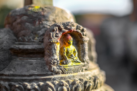 Small statue of Buddha carved in the stoneの写真素材