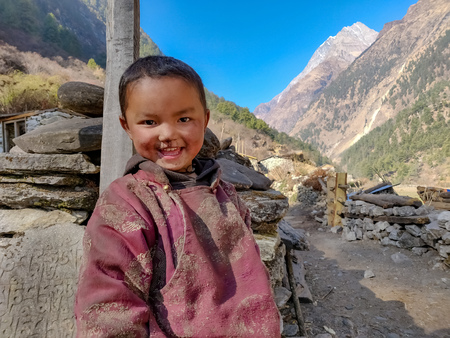 Gorkha, Nepal - December 22 2018: A Sherpa kid smiling at the camera in the remote village of Nepalのeditorial素材