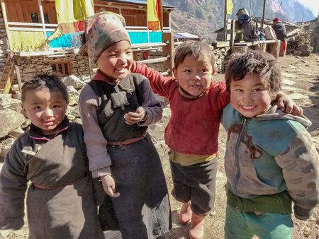 Gorkha, Nepal - December 22 2018: A Sherpa kids smiling at the camera in the remote village of Nepalのeditorial素材