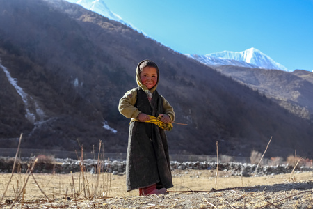 Gorkha, Nepal - December 22 2018: A Sherpa kid smiling at the camera in the remote village of Nepalのeditorial素材