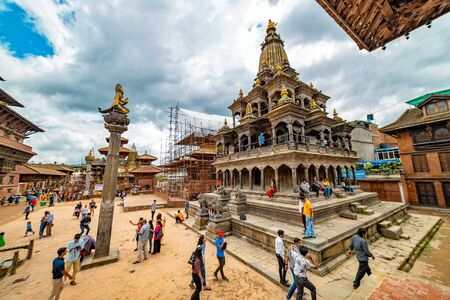 Kathmandu, Nepal - July 27 2019: People admiring and walking around Krishna Temple located at Patan Durbar Square premises in Nepal.のeditorial素材
