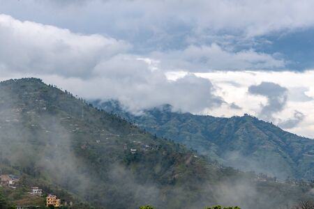 Hills covered by clouds and fog during rainy seasonの写真素材