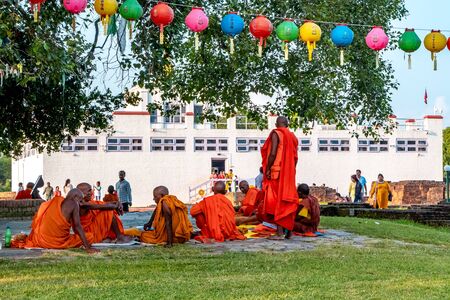 Senior Buddhist monks sitting infront of Maya Devi Temple at Lumbini, Nepalのeditorial素材