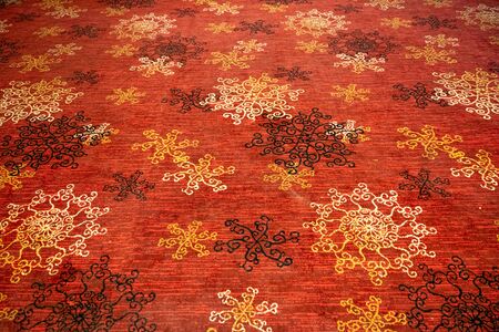 Circular flower shaped designs on a floor mat or carpetの写真素材