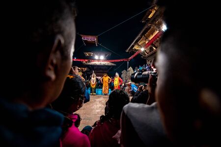 Patan, Nepal - November 8 2019 - Nepalese people performing and watching traditional dance called Kartik Naach during night time at Patan Durbar Square premises.のeditorial素材