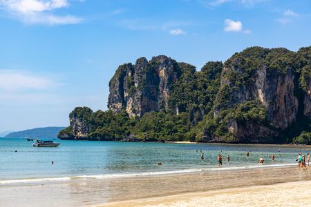 Krabi Town, Thailand - November 23 2019: Tousiting sunbathing at the beautiful Railay Beach in Krabi Town, Thailand.のeditorial素材