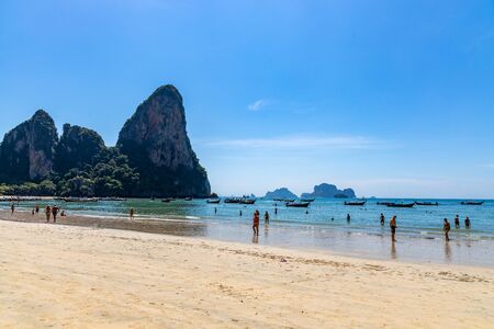 Krabi Town, Thailand - November 23 2019: Tousiting sunbathing at the beautiful Railay Beach in Krabi Town, Thailand.のeditorial素材