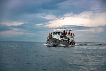 Phi Phi Island, Thailand - November 24 2019: A ferry ship with passengers onboard sailing towards...