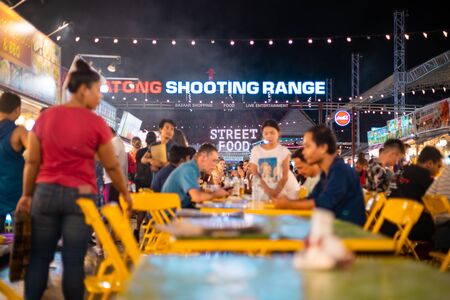 Phuket, Thailand - November 26 2019: People enjoying local delicacies at a Night market in Phuket near Patong beach area.のeditorial素材