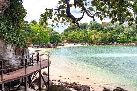 Wooden walkway ramp on the shore of Andaman Sea. Famous tourist attraction. Tropical Beach. Perfect summer getaway.の写真素材