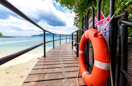 Wooden walkway ramp on the shore of Andaman Sea. Famous tourist attraction. Tropical Beach. Perfect summer getaway.の写真素材
