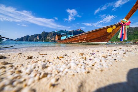 traditional wooden longtail boats parked at a beach in Phi Phi Island. Clear water and clean beach.の写真素材