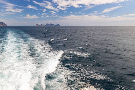 Waves from a ferry boat sailing awa from Phi Phi Islands in Thailand.の写真素材