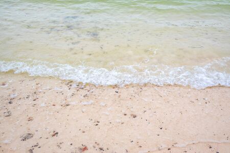 Silent sea waves crashing on a beach at Phi Phi Islands in Thailand.の写真素材