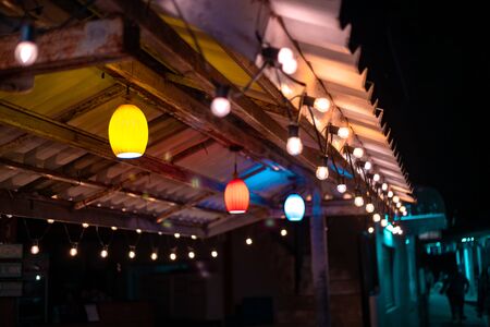 Colorful lights hanging in the roof at night time. decoration concept. selective focus.の写真素材