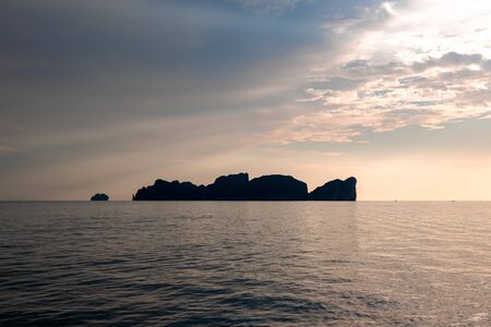 Dramatic Silhouette of mountains in the middle of andaman sea near Phi Phi Islands during sunset.の写真素材