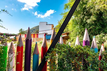 Colorful crayon pencils placed as a fence surrounding a gardenの写真素材