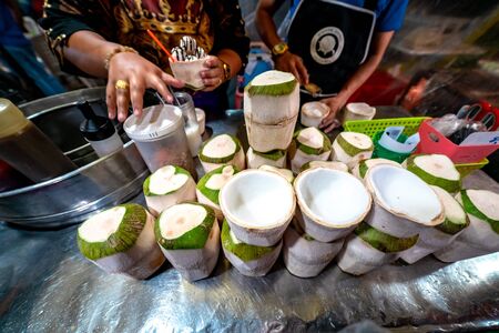Locals selling coconut icecream at Krabi Weekend Night Market in Krabi Town, Thailand.の写真素材