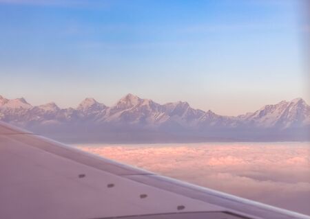 Himalayan mountain range during dusk seen from flight.