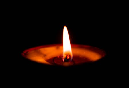 Butterlamp / Wax Candles / Diwali batti / Diya Burning in the dark. One Butter lamp glowing in the dark. selective focusの写真素材