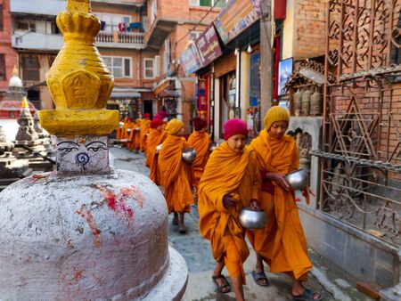 Kathmandu, Nepal - December 17 2019: Young Buddhist monk circulating a Buddhist gompa. Selective...