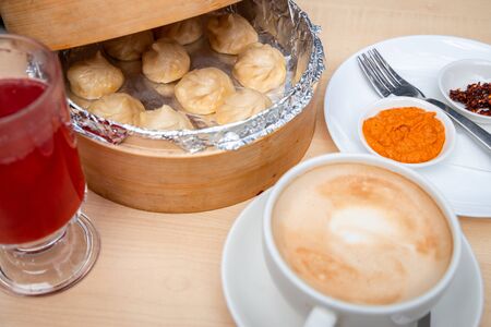 Dumpling, blueberry juice, coffee and homemade sauce top view.