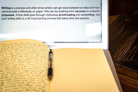 Blogger concept. There is a pc laptop with notebook and pen at a table in a cafe. selective focusの写真素材