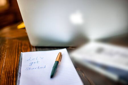 Blogger concept. There is a pc laptop with notebook and pen at a table in a cafe. selective focus