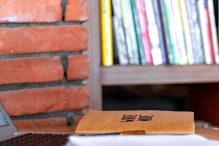 Blogger concept. There is a pc laptop with notebook and pen at a table in a cafe. selective focusの写真素材