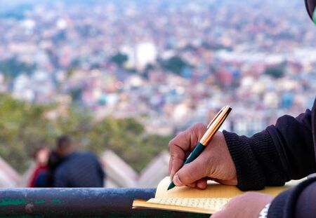 Hand of a young businessman taking notes with a fountain pen on a notecopy.  Student learning online. Blogger. selective focusの写真素材