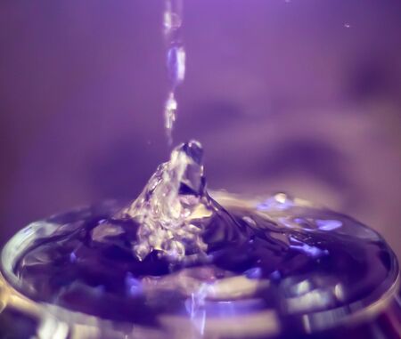 water drop splash in a glass backgroundの写真素材