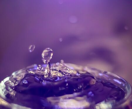 water drop splash in a glass backgroundの写真素材