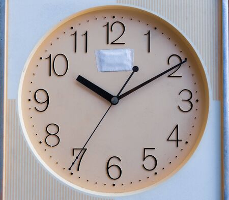 analog clock pointing hour hand at 10, minutes hand at 2 and seconds hand at 7. selective focus