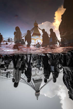 Kathmandu, Nepal - June 30 2019: Crowd of Buddhist Devotees Circulating the holy Boudhanath Stupa on...