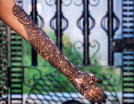 Hands of woman with detailed henna design artの写真素材