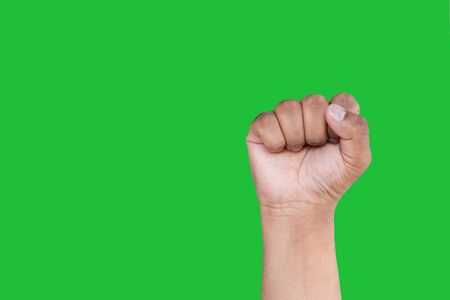 Hand of an Asian man forms Fist isolated on a green screen background.の写真素材