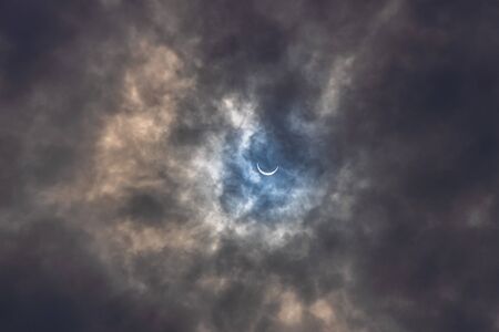 Surreal Dramatic Solar Eclipse Covered By Clouds. Natural Phenomenon.の写真素材