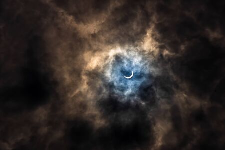 Surreal Dramatic Solar Eclipse Covered By Clouds. Natural Phenomenon.