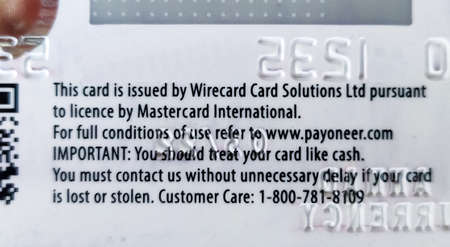 Bhairahawa, Nepal - June 27 2020: Message on the back side of the Payoneer card shows it was issued by Wirecard Card Solutions Ltd.のeditorial素材